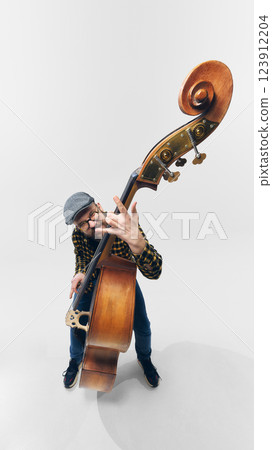 Rockstar bassist bending strings with intensity, fully immersed in rebellious and powerful musical moment. Rockstar bassist bending strings with intensity, fully immersed in rebellious and powerful musical moment. 123912204