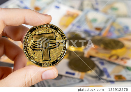 tether cryptocurrency coin on a background of blurred euro and dollar bills, symbolizing digital finance, stablecoin investments, and modern economic trends 123912276