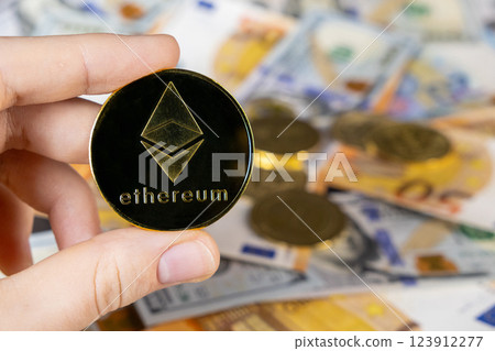 ethereum cryptocurrency coin with a blurred background of euro and dollar bills, representing digital finance, blockchain technology, and modern investment opportunities 123912277