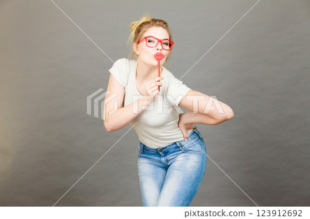 Happy woman holding carnival accessoies on stick Happy woman holding carnival accessoies on stick 123912692
