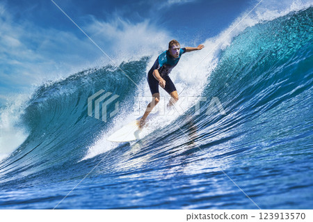 Male surfer on a blue wave 123913570