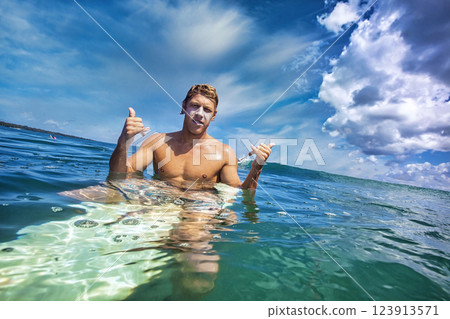 Male surfer in an ocean Male surfer in an ocean 123913571