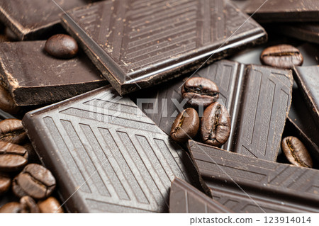Dark chocolate pieces with coffee beans close-up. Dark chocolate pieces with coffee beans close-up. 123914014