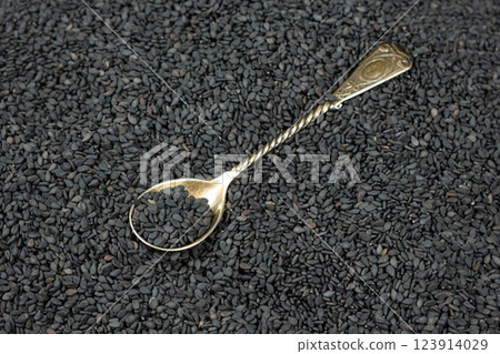 Natural black sesame grains in a spoon close-up Natural black sesame grains in a spoon close-up 123914029