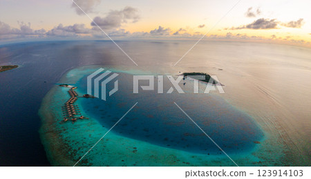 Aerial views of Velavaru Island at sunset in Maldives 123914103