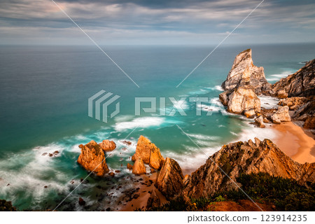 Ursa Beach. Dramatic cliffs meet the turquoise ocean at Cape Roca, Portugal, on a cloudy day. 123914235
