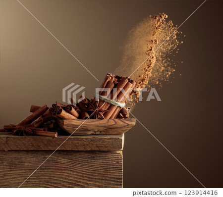 Cinnamon sticks and powder on a brown background. Cinnamon sticks and powder on a brown background. 123914416