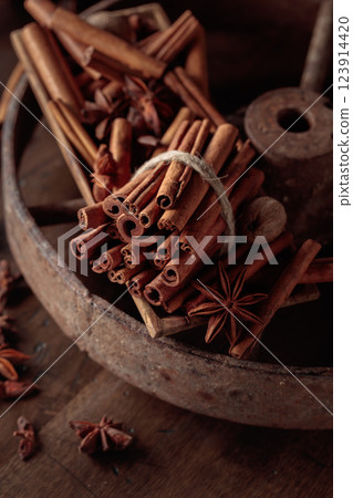 Cinnamon sticks, anise, and nutmeg on a wooden table. 123914420