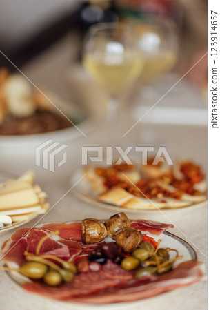 Two glasses of cool champagne and plates with various snacks on a table Two glasses of cool champagne and plates with various snacks on a table 123914657