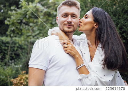 Portrait of young smiling couple in love against backdrop of garden or nature. 123914670