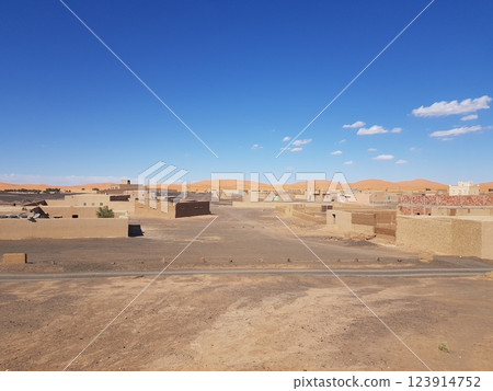 A desert landscape with blue sky and mountains in the background 123914752