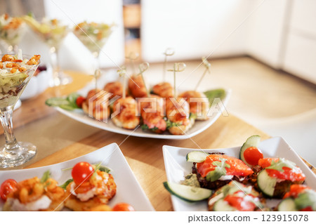 Close-up of delicious snacks on a wooden table in the dining room at home Close-up of delicious snacks on a wooden table in the dining room at home 123915078
