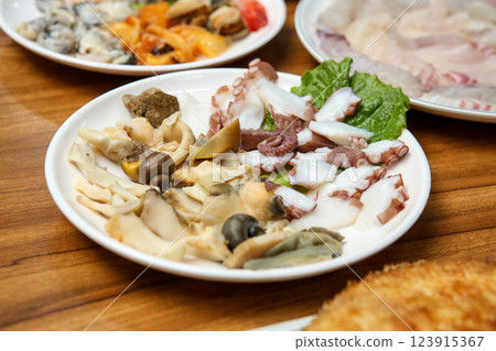 Korean seafood dish. Boiled conch and octopus sashimi Korean seafood dish. Boiled conch and octopus sashimi 123915367