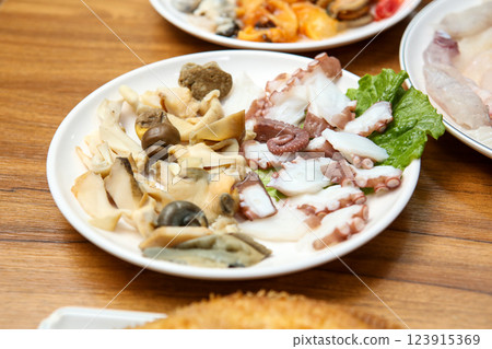 Korean seafood dish. Boiled conch and octopus sashimi Korean seafood dish. Boiled conch and octopus sashimi 123915369