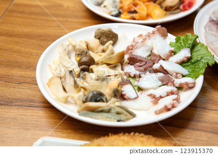 Korean seafood dish. Boiled conch and octopus sashimi Korean seafood dish. Boiled conch and octopus sashimi 123915370
