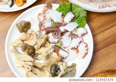Korean seafood dish. Boiled conch and octopus sashimi 123915374