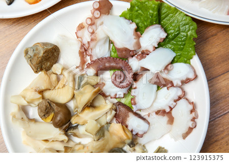 Korean seafood dish. Boiled conch and octopus sashimi 123915375