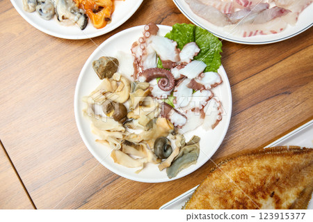 Korean seafood dish. Boiled conch and octopus sashimi Korean seafood dish. Boiled conch and octopus sashimi 123915377