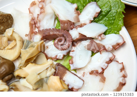 Korean seafood dish. Boiled conch and octopus sashimi Korean seafood dish. Boiled conch and octopus sashimi 123915383