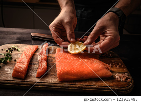Chief cooking salmon red fish for healthy dinner with Omega-3 and vitamins 123915485