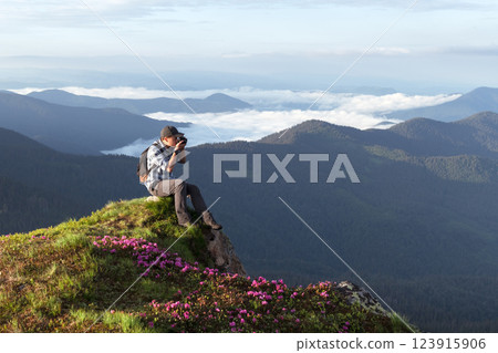 Scenic mountain landscape with a photographer at the edge Scenic mountain landscape with a photographer at the edge 123915906