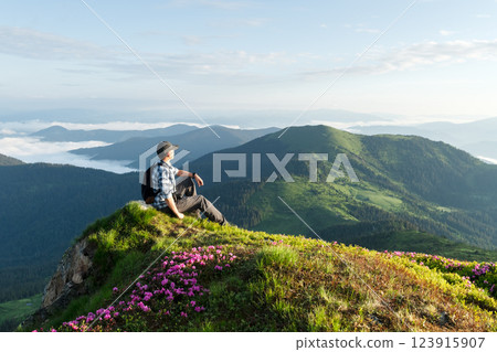 Scenic mountain landscape with a tourist 123915907