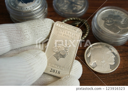 Australian silver investment coin in the hands of a numismatist. 1 dollar 1oz Ag 9999 123916323