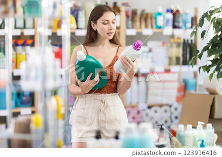 Woman consumer with household chemical products for washing indoors 123916416