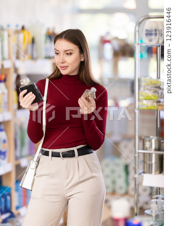 Young woman chooses perfume in store Young woman chooses perfume in store 123916446