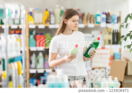 Girl view trademark sign on label, chooses eco friendly dishwashing detergent Girl view trademark sign on label, chooses eco friendly dishwashing detergent 123916471