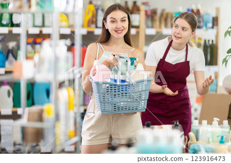Young woman seller offers household chemicals to woman 123916473
