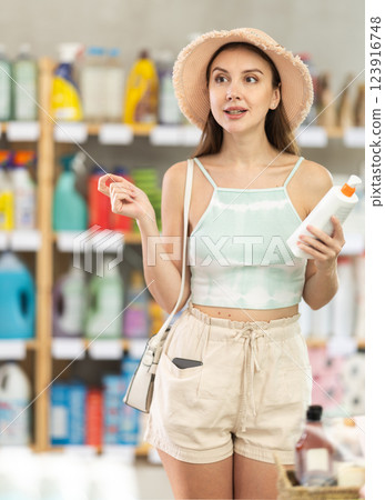 Woman view trademark sign on label, chooses eco friendly sunblock cream Woman view trademark sign on label, chooses eco friendly sunblock cream 123916748