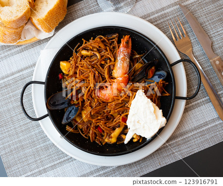 Spanish seafood fideua, noodle paella with aioli Spanish seafood fideua, noodle paella with aioli 123916791