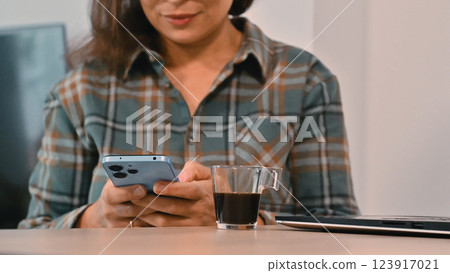 Modern Remote Work Scene with Mobile Phone and Coffee Modern Remote Work Scene with Mobile Phone and Coffee 123917021