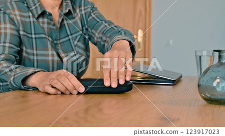 Woman's Hands on a Case Beside Laptop at a Wooden Desk Woman's Hands on a Case Beside Laptop at a Wooden Desk 123917023