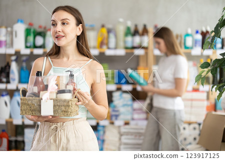 Young woman buyer chooses cosmetics gift set Young woman buyer chooses cosmetics gift set 123917125