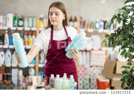 Girl store employee working in sales area Girl store employee working in sales area 123917255