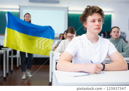 Teacher with the flag of Ukraine tells the history of the emergence of state Teacher with the flag of Ukraine tells the history of the emergence of state 123917347
