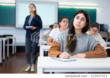 Young girl student diligently studies at school 123917351