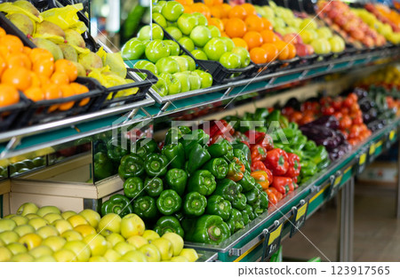 Stand with variety of vegetables and fruits in supermarket Stand with variety of vegetables and fruits in supermarket 123917565
