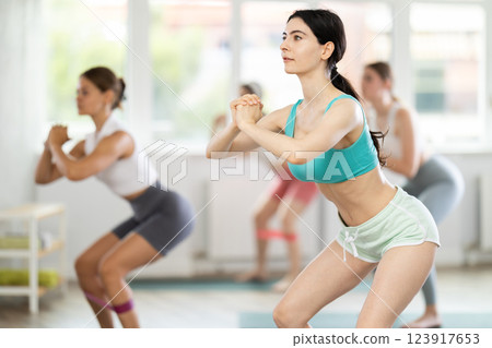 Training leg muscles and using resistance bands in Pilates classes for women 123917653