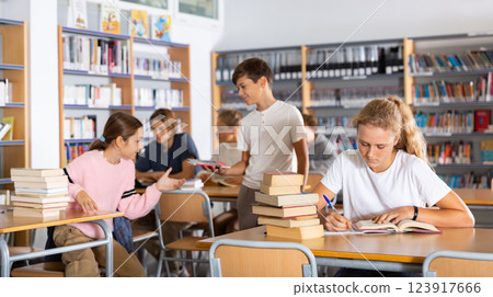 Fifteen-year-old girl writes out a synopsis Fifteen-year-old girl writes out a synopsis 123917666