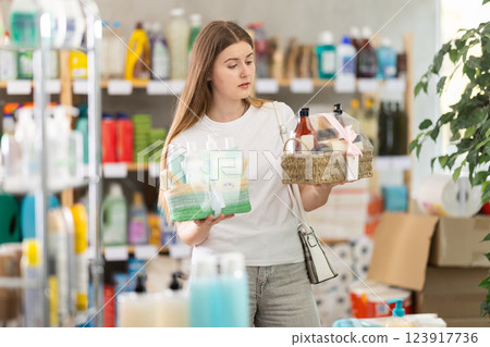 Smiling girl shopping presents at home goods store Smiling girl shopping presents at home goods store 123917736