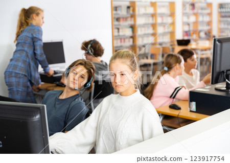Teenager girls and boys studying in computer lab Teenager girls and boys studying in computer lab 123917754