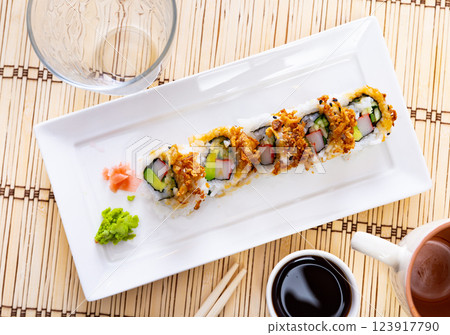 Plate is filled with crunch California rolls with fried puffed rice Plate is filled with crunch California rolls with fried puffed rice 123917790