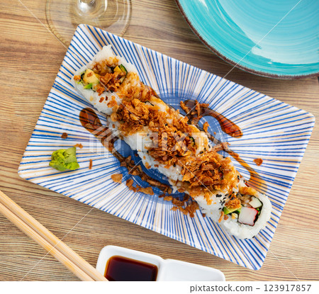 Plate is filled with crunch California rolls with fried puffed rice 123917857