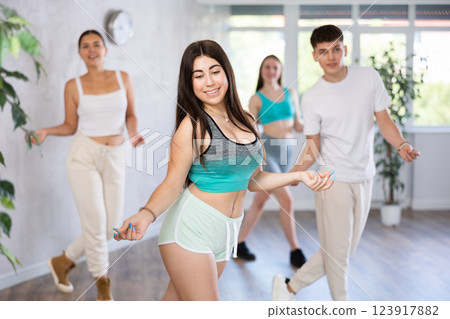 Active teenagers dancing modern dances in modern studio Active teenagers dancing modern dances in modern studio 123917882