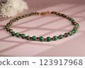 Malachite necklace photographed on a pink background 123917968