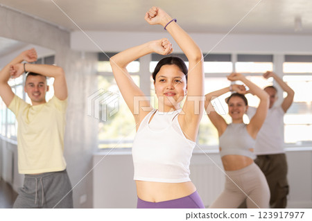 European girl with team of like-minded multinational people learn to elements of electro dance European girl with team of like-minded multinational people learn to elements of electro dance 123917977