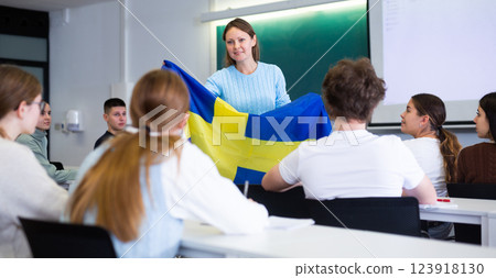 Female professor shows students flag of Sweden Female professor shows students flag of Sweden 123918130